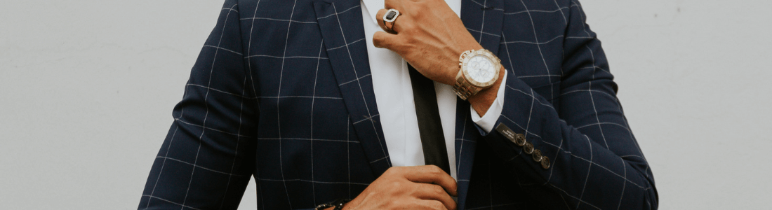 man adjusting tie 