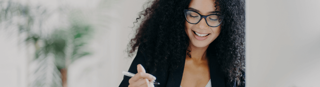 smiling woman with a pen 